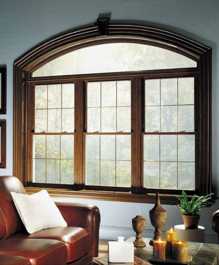 Set of three replacement woodgrain double-hung windows with arched window over the top, in a living room.