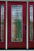 Red front door with decorative glass and sidelites.