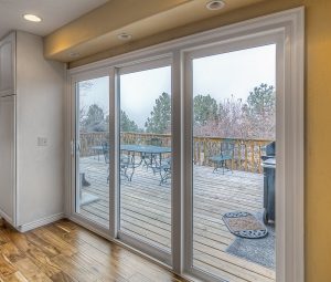 Sliding glass doors that open up to a deck of a house.