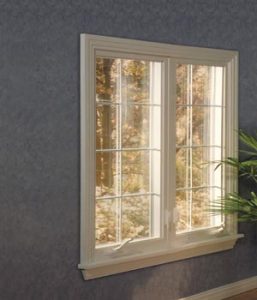 Replacement white-framed casement windows with grids.
