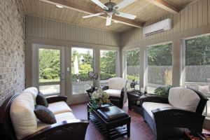 Outside sun room with brick floors and large energy efficient windows letting in sunlight