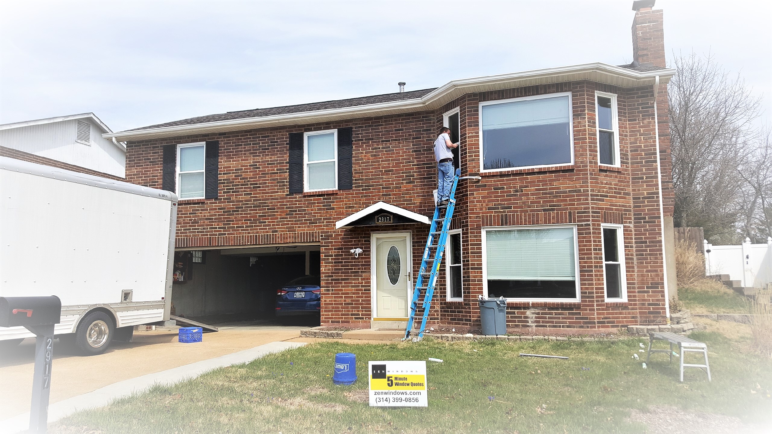 home during window replacement with Zen Windows sign out front