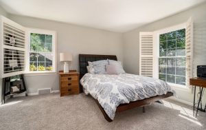 bedroom with white double-hung grid windows installed.