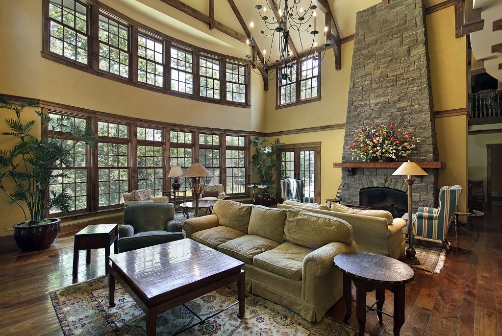 A large living room featuring several windows with wooden frames.